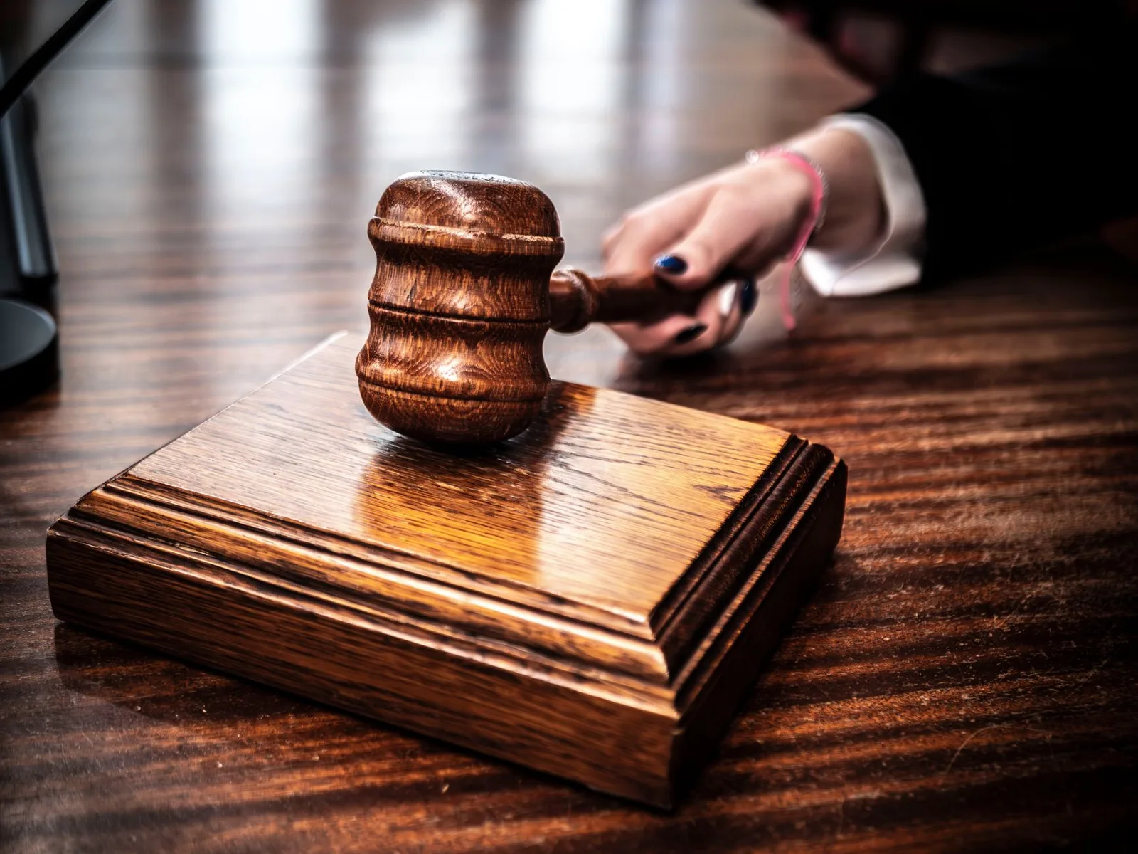 Wooden gavel resting on a judge's desk