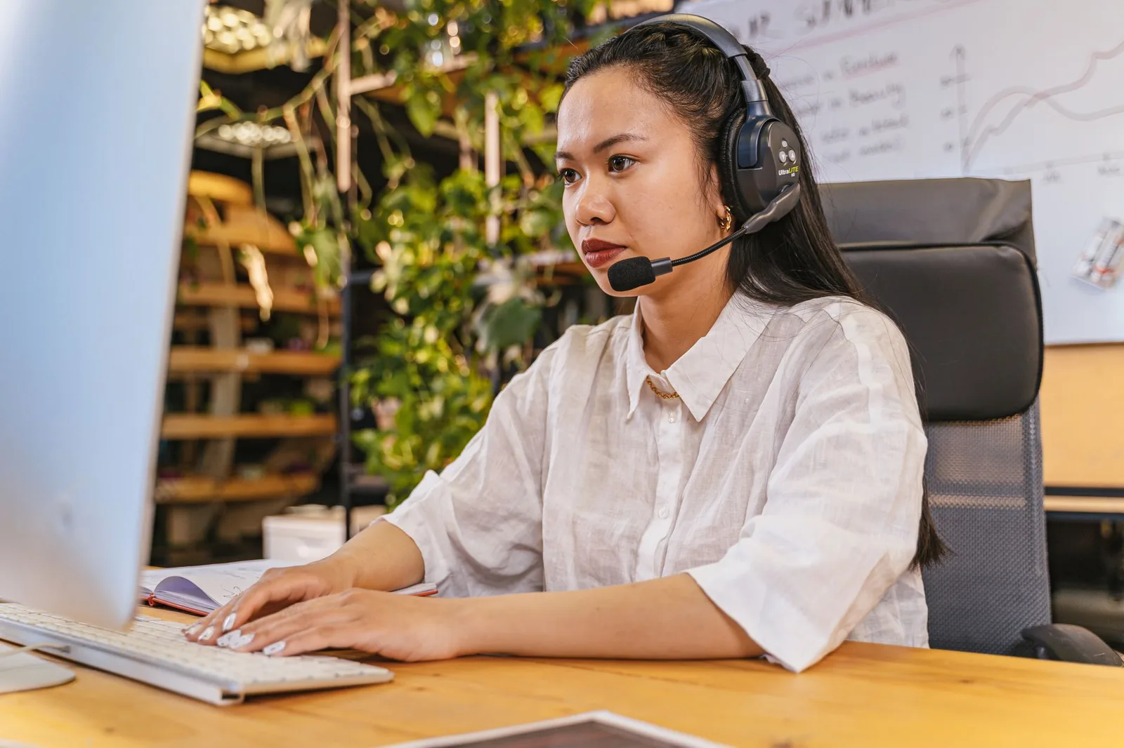 Transcription professional working at a computer with a headset