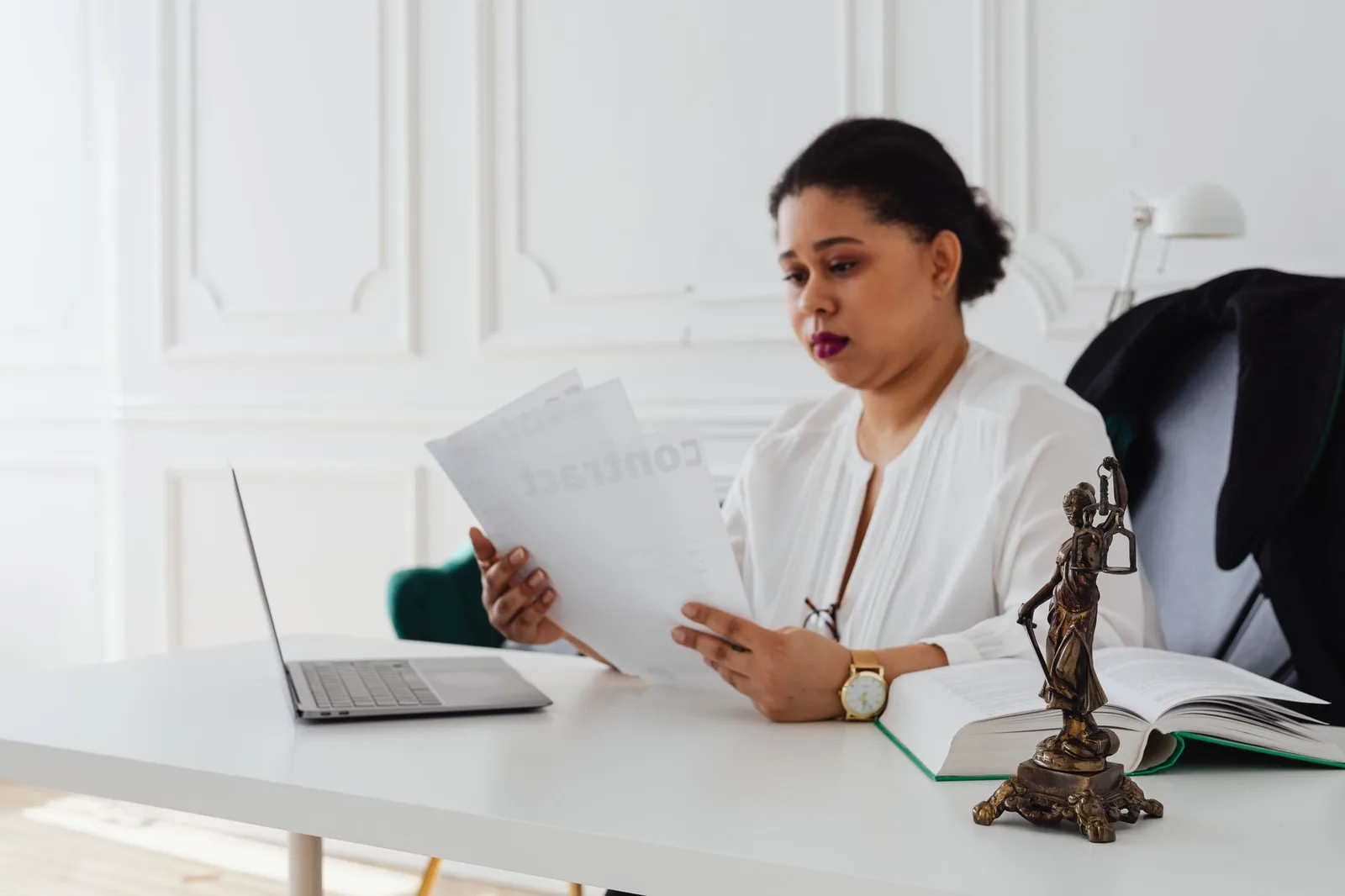 Attorney reviewing legal papers at her desk